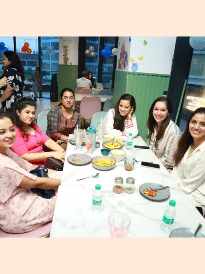 The moms' table. While the kids play, parents can relax, socialize, and enjoy our cafe's offerings.