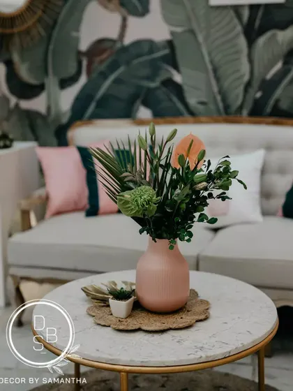 The pink and green color palette celebrated the couple's "opposites attract" love story. Even the table centerpieces, with tropical flowers and playful elements, reflected this theme.