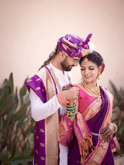 An intimate portrait where the couple's foreheads touch. This shot emphasizes their connection and the beautiful coordination of their traditional wedding attire.