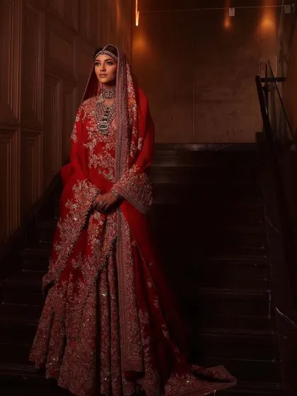 A dramatic shot of a bride on a staircase. We teach you how to create looks that are not only beautiful but also photogenic. Join my Ludhiana masterclass to learn more.