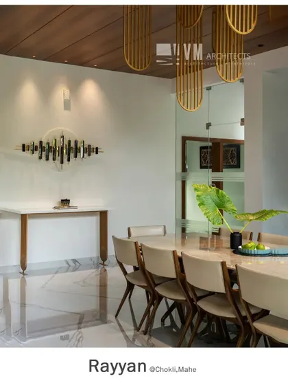 A minimalist console table and metallic wall art complement the dining area at Rayyan, showcasing a clean, sophisticated aesthetic with high-end finishes.