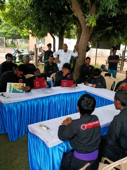 Students sit for a theory session during a belt test. Knowledge of the art's history, philosophy, and principles is a required part of their martial arts education.