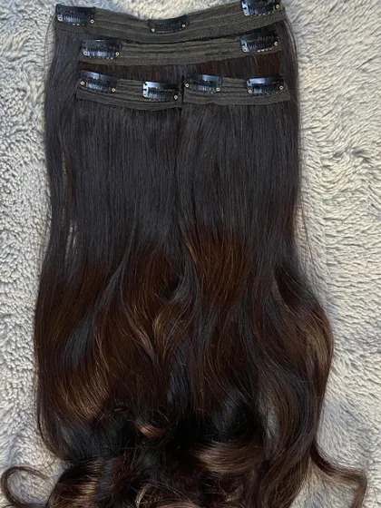 A full set of 4 clip-on extensions, ready for a client. This set is perfect for adding significant volume and length for a big event.