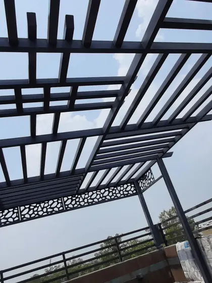 The combination of the geometric roof and the pebble-patterned CNC panels gives this pergola a unique and contemporary look.