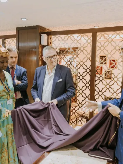 A moment of decision during a fabric consultation. We are showcasing a luxurious purple cloth to our esteemed guests from the Belgium Trade Commission, demonstrating the drape and feel that cannot be appreciated from a swatch alone.
