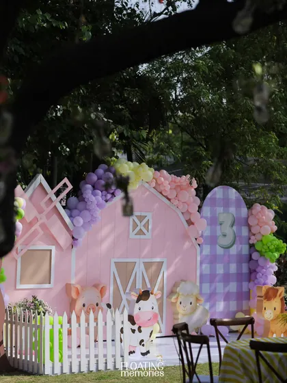 Another view of the main stage area, showing how the different elements come together. The pastel barn, balloon garlands, and character cutouts create a cohesive and visually delightful scene for a child's birthday.