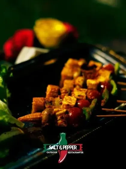 A close-up of my grilled paneer tikka skewers, showcasing the vibrant colors of the bell peppers and the perfect char on the paneer. A vegetarian delight for any event.