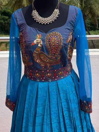 A close-up of the intricate peacock embroidery.