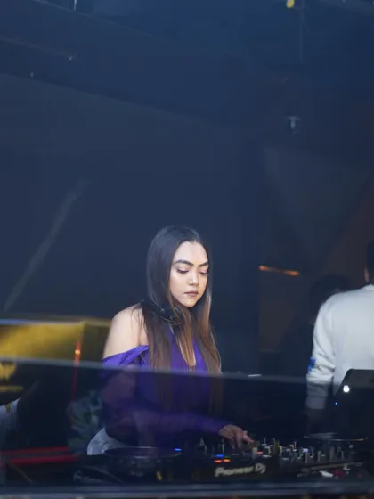A quiet, focused moment at the console, bathed in purple light.