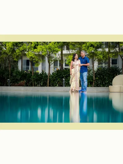 A serene family portrait by the pool, capturing a quiet moment of connection.