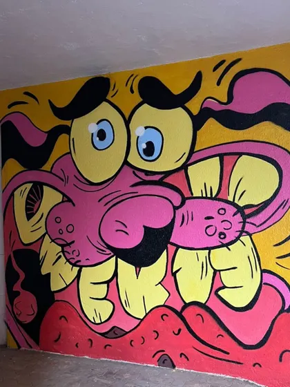 The full view of the Courage mural, a piece of pop culture street art that brings a smile to everyone who grew up with him.