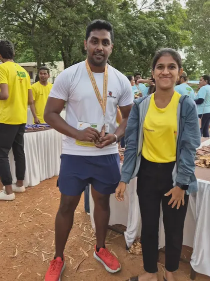 Posing with a team member after the Mysuru Run. Every finish is a victory for the whole team.