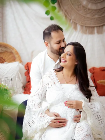 A beautiful portrait of a couple in a light-filled, boho-chic setting. Their loving embrace and serene expressions create a truly magical photo.