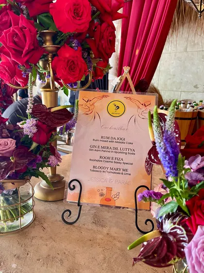 A custom-designed cocktail menu for an Indian wedding. The drink names, like 'Rum Da Jogi' and 'Gin E Mera Dil Luteya', were created to match the fun, celebratory theme of the event.