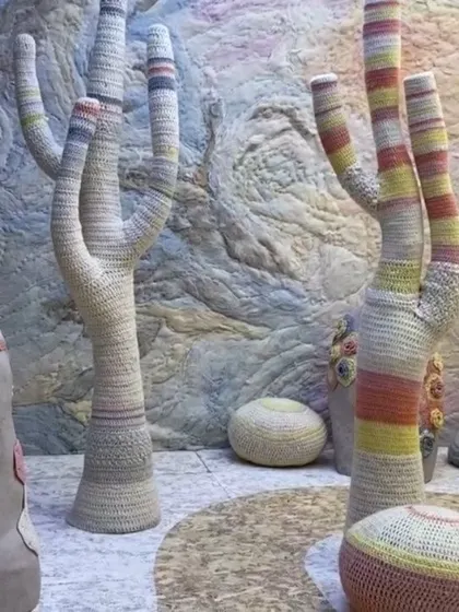 A closer look at the crocheted tree-like forms in our 'Hope You're Well' installation. The use of handcraft and soft, striped patterns emphasizes a message of empathy and wellbeing, creating a tactile and visually gentle environment.