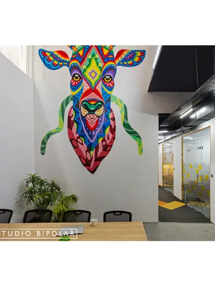 A closer look at the intricate and colorful mural that defines this workspace. The artwork is a key element that prevents the open-plan office from feeling generic and adds a layer of visual interest.