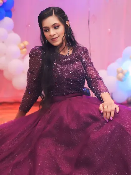 A dreamy pose in a sparkling purple gown. This dress is perfect for making a wish and celebrating another year in style.