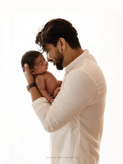 A father's first connection with his newborn. This high-key portrait captures the tender and quiet moment between a dad and his baby.