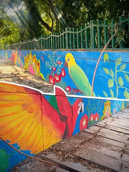 A different angle of the Sector 27 mural, with sunlight filtering through the trees. This shot captures the harmony between the artwork and its natural surroundings.