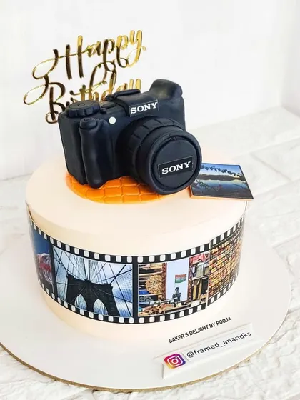 A cake for a photography enthusiast. This design features a fully edible, handcrafted Sony DSLR camera made from fondant, sitting atop a cake decorated with a film strip of their photos.