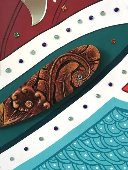Another detail shot of the abstract entrance mural, highlighting a carved, wooden-textured 3D element surrounded by painted patterns and decorative gems. We love combining different materials in our work.