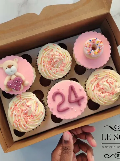 A sweet set for a 24th birthday celebration. This box features a mix of buttercream swirls and custom fondant toppers, including a tiny teddy bear holding a heart, the number 24, and a miniature donut.