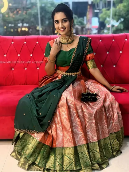 A happy smile in our traditional half saree, a testament to how our outfits make you feel special.