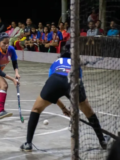 A player attempts a shot on goal during the exhibition match, with the crowd watching in the background. We provide our players with opportunities to perform in front of an audience.