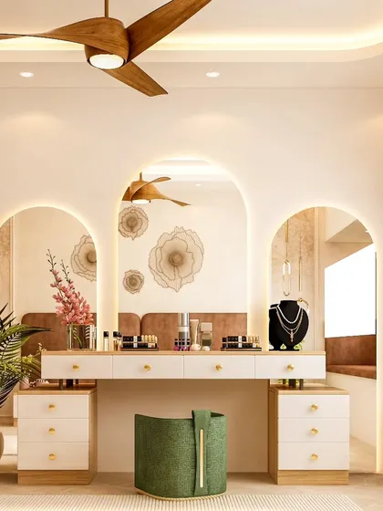 A beautiful dressing area featuring a triple-arched mirror with soft backlighting. The white vanity provides ample storage, while the wooden fan and indoor plant add a touch of natural, bohemian charm.