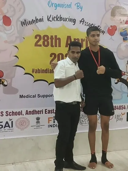 A student stands tall with his medal after the competition. We focus on building not just fighters, but disciplined individuals who carry themselves with confidence.