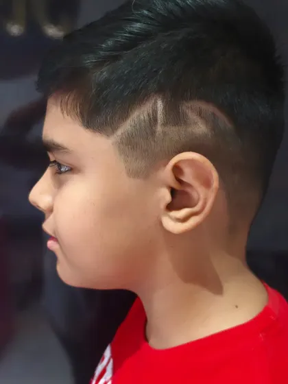 A cool side design adds a fun touch to this boy's haircut.