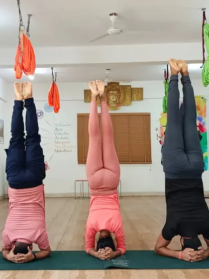 A synchronized line of headstands, Sirsasana, showcasing the strength and focus of our dedicated students.