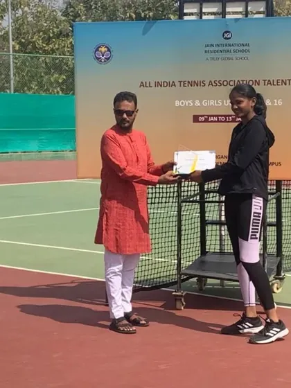We congratulate our junior player Sathvika on her tournament success. Here she is receiving her award.