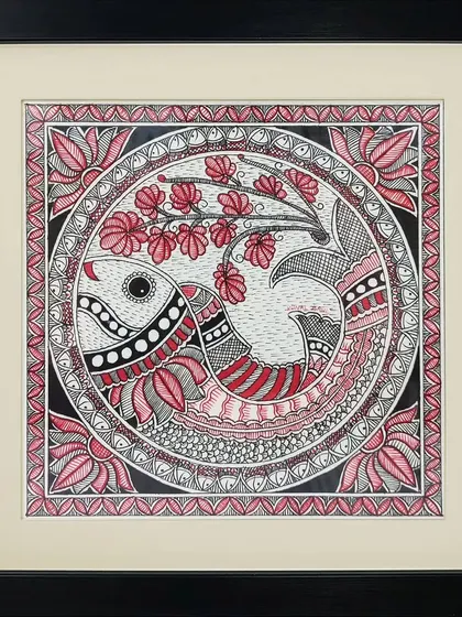 The sacred 'Om' symbol is creatively represented as a fish in this Madhubani painting by Anu Bansal. The piece is filled with intricate floral and geometric patterns in a striking red, black, and white palette.