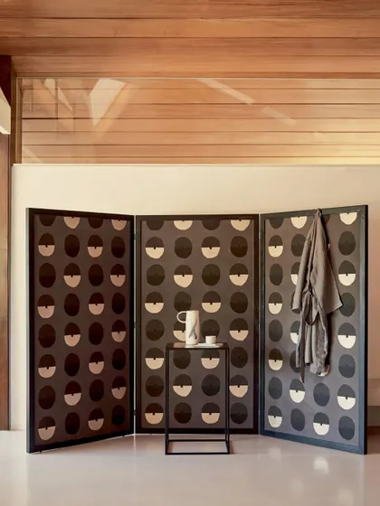 The 'Royal Emblème' design used on a folding screen. This demonstrates the versatility of our wallcoverings, which can be applied to furniture and other objects to create bespoke decorative pieces.
