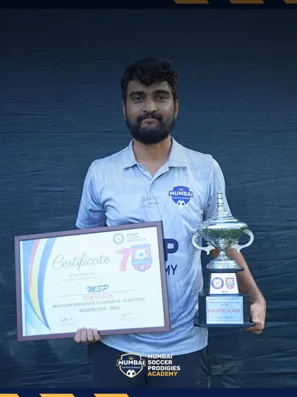 Our coach proudly displays the trophy and certificate for our U15 team's fourth-place finish.