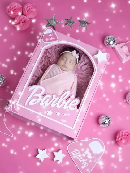 A sparkling and glamorous Barbie-themed newborn portrait. We love bringing creative and playful ideas like this to life for our clients.