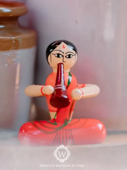 A close-up of a traditional Channapatna toy, used as a unique decor element for a carnival-themed Mehendi. We love incorporating local crafts to add a special, authentic touch.