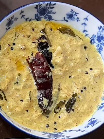 My Pineapple Pachadi is a divine side dish that balances sweet, tangy, spicy, and pungent flavors. It's made with sweet pineapple, yogurt, and a ground coconut paste, tempered with mustard seeds and red chilies.