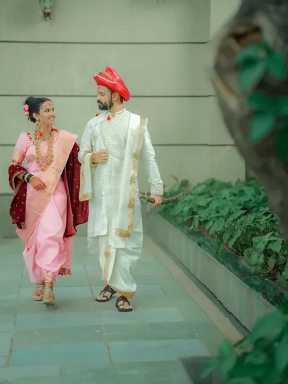 A candid, walking shot of the couple. The natural movement and interaction create a dynamic and authentic portrait.