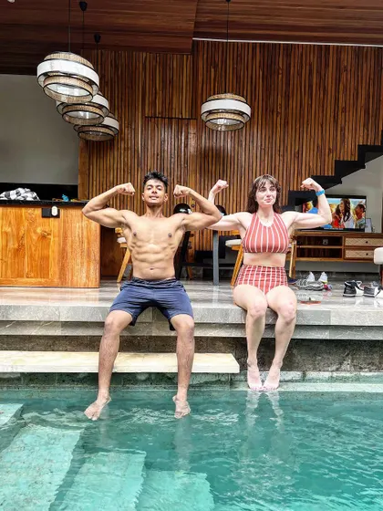 Flexing with a friend by the pool. Fitness is more fun when you share it with others.