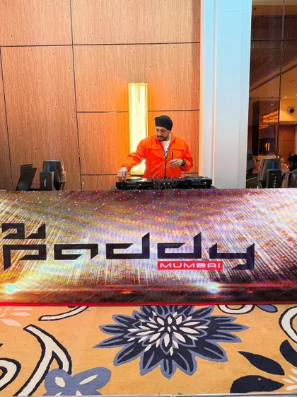 A final check of the DJ console before the guests arrive for a wedding after-party. The custom LED booth adds a professional and personalized touch to the entire setup.