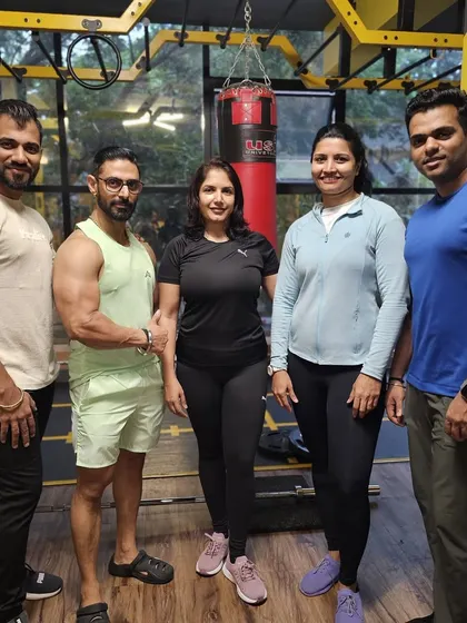 The team that makes it happen. A client celebrating her success with the coaches who guided her through her functional medicine and fitness journey.