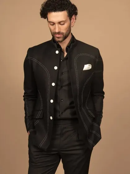 Get into elegance with my designer black Bandhgala, featuring intricate abstract contrast thread stitching. This adds a touch of artistry and sophistication to your ensemble.
