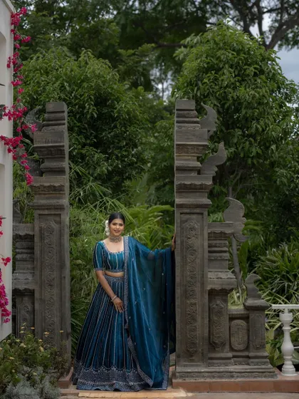 Another beautiful shot in a garden setting. The natural light makes her skin glow, and the makeup looks fresh and radiant.