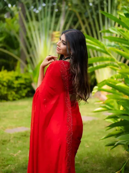 A portrait from the back, showing the elegant drape of the saree and the bride's beautiful hair. It's a unique angle that adds variety to a gallery.