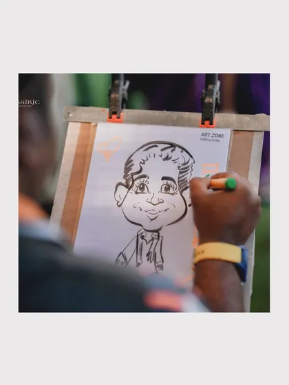 A duplicate image of the talented caricature artist at work.