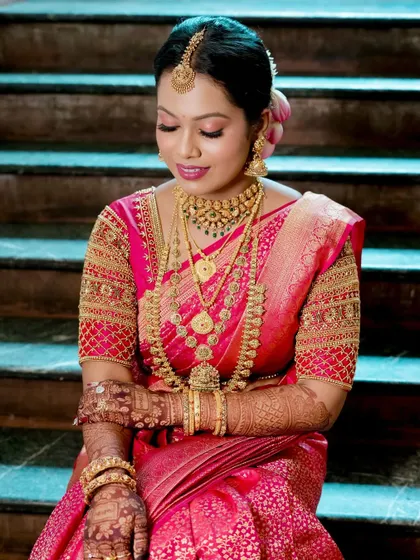 A serene and elegant shot of Lavanya on the stairs, capturing the timeless beauty of her South Indian bridal look.
