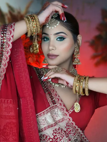 Every pose tells a story. Notice the intricate details, from the alta on her hands to the perfectly placed jhumkas, complementing the classic bridal makeup.