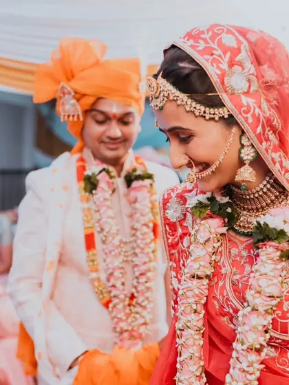 The bride's shy smile as she walks with her groom, a beautiful, unposed moment that captures the essence of the day.
